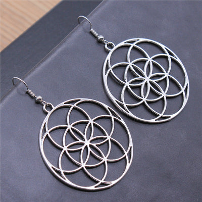 Hand held view of circle flower earrings