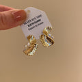 Gold Tone Textured Fan Twist Stud Earrings with Crystals view 6