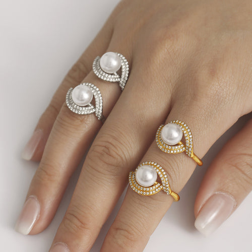 Hand wearing gold and steel faux pearl zircon double curve rings