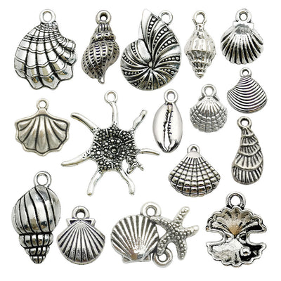 Metallic seashell charms arranged on a light background