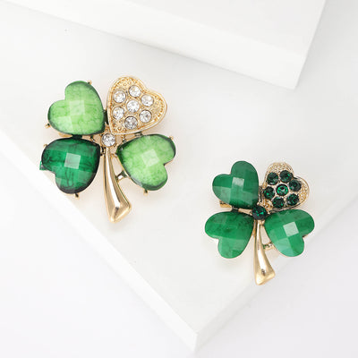 Two green four-leaf clover brooches with clear and green rhinestone leaves