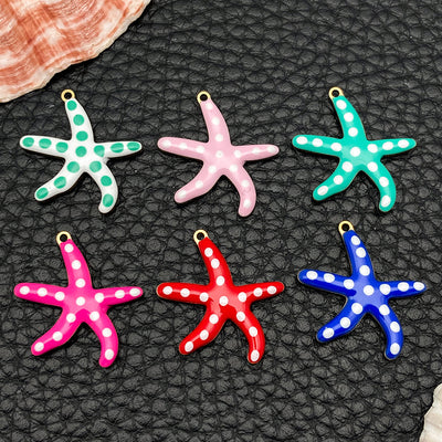 Gold-tone starfish charms arranged on a light background