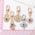 Gold and Silver Tone Geometric Hamsa and Eye Clip Keychains view 4