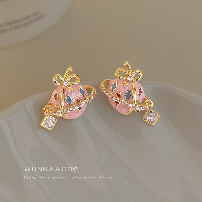 Gold Tone Pink Planet Bow And Clear Stone Stud Earrings