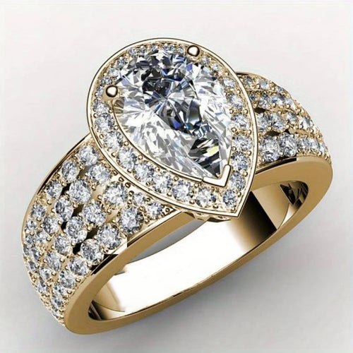 Side-front studio shot of gold teardrop halo multi-row pave ring