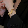 Wide Polished Wave Hinged Bangle In Gold Or Silver Tone view 3