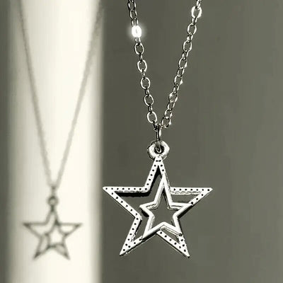 Silver hollow dotted star pendant necklace close-up with shadow