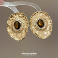 Textured Gold Tone Oval Stud Earrings With Brown Centers view 1
