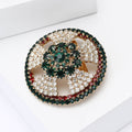 Round Crystal Wreath Brooch Emerald Center Red Green Rim view 3
