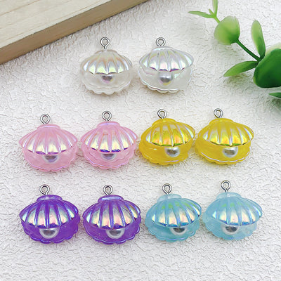 Iridescent shell charms arranged on a light background