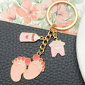 Eight Pink Baby Outfit and Footprint Metal Keychain Designs view 3