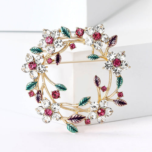 floral wreath brooch displayed on a product backdrop