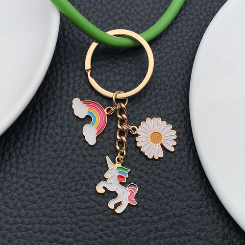 Alternate arrangement of the colorful rainbow unicorn daisy and cloud metal keychain showing its hardware and charm deta