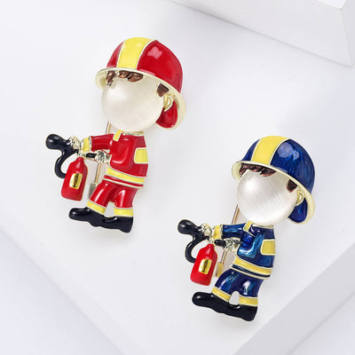 Front view of the enamel firefighter brooch holding an extinguisher decorative clothing pin on a white background
