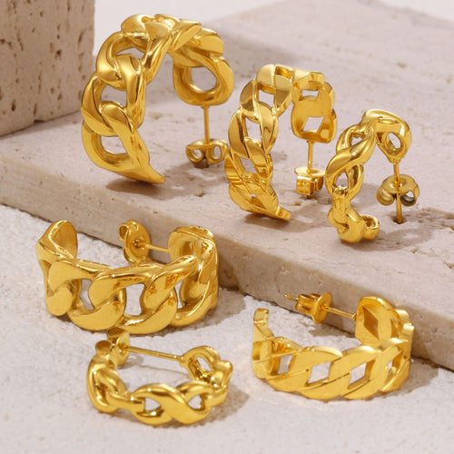 Assorted gold geometric chain C-hoop earrings on stone