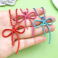 Butterfly Charm Keychains Featuring Magenta Bow Across 17 Pictured Variations view 2