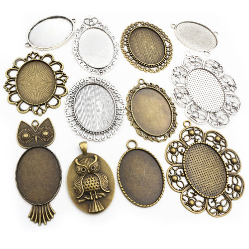 Image 1 showing oval double-sided pendant bezels in thirteen ornate designs in the pictured colors and forms