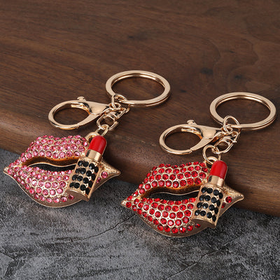 Red and pink rhinestone lips and lipstick keychains displayed side by side.