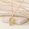 Gold Tone Sculpted Hand, Foot and Ear Pendant Necklaces view 3