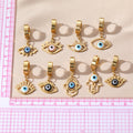 Gold Tone Hamsa Star and Lash Evil Eye Huggie Drop Earrings view 4