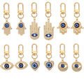 Twelve Piece Gold Tone Crystal Hamsa Heart and Evil Eye Keychain Set view 1