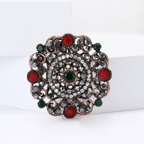 Round vintage brooch on white blocks red cabochon detail