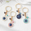Gold Tone Round Rhinestone Evil Eye Keychains in Four Colors view 1