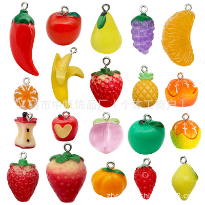 Multicolor apple charms arranged on a light background