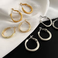 Round Huggie Hoop Earrings In Gold Silver Polished And Matte view 4