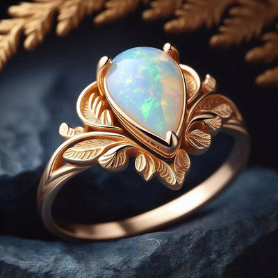 Studio front view of champagne gold leaf teardrop opal ring