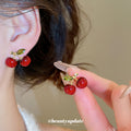 Glossy Red Cherry Stud Earrings With Green Leaf Accents view 1