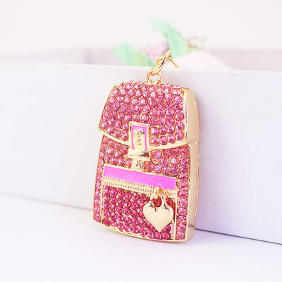 Pink rhinestone backpack charm shown from the front at a slight angle.