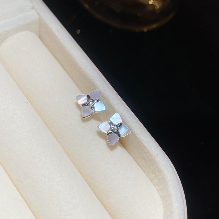 White Four Petal Flower Crystal Stud Earrings With Polished Metal Details
