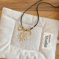 Gold Tone Sun and Moon Pendant Necklace on Black Cord view 4