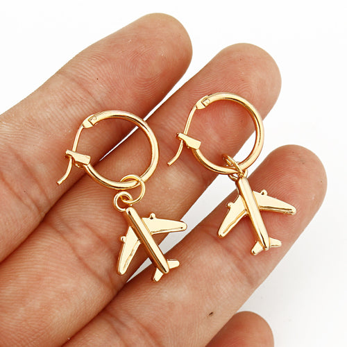 Close-up showing the colors and surface details of gold and Silver Tone Airplane Huggie Drop Earrings