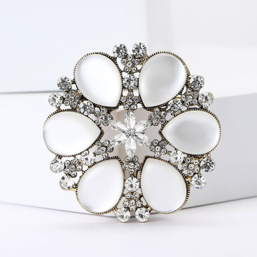 Crystal Framed Cat Eye Cabochon Flower Brooch in Gray and White front view on a white background