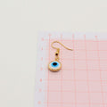 Gold Tone White and Blue Evil Eye Drop Earrings with Hooks view 3