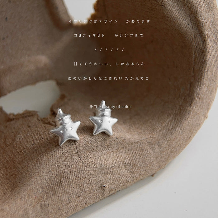 Silver Tone Matte Sculpted Star And Clear Stone Stud Earrings