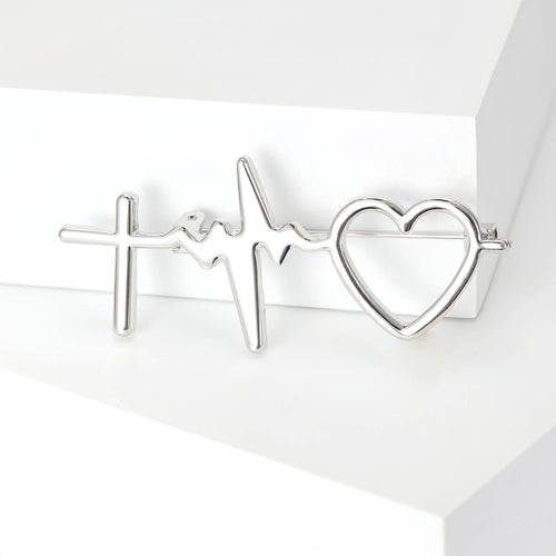 Silver heartbeat cross heart brooch close-up