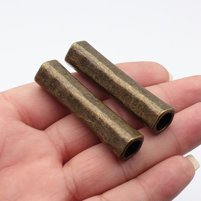 Antique Bronze long plain tube large hole bead shown in front view