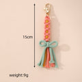 Gold Tone Woven Daisy Bow Tassel Clip Keychains in Four Colors view 4