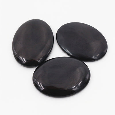 Oval cabochons arranged assortment on a white background