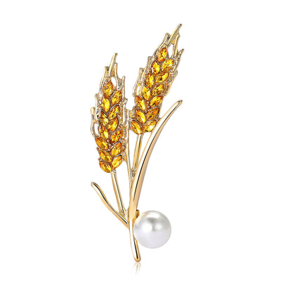 Front view of the wheat stalk brooch showing gold-tone wheat stalks with a white faux pearl
