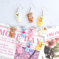 Miniature Flocked Bow Bear Hook Earrings in Four Colors view 1