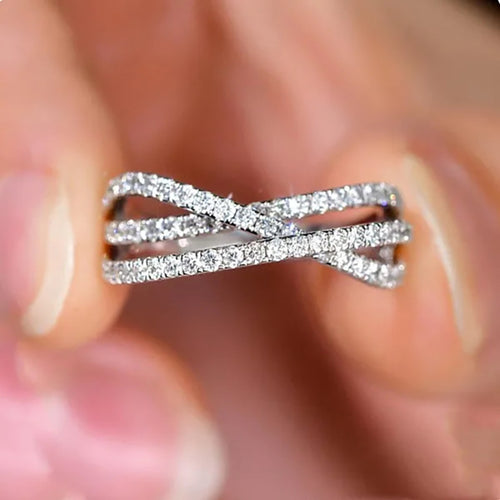 Close-up of crossed X bands held between fingers