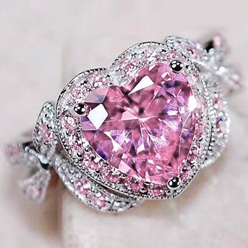 Additional product view showing pink heart solitaire looping leaf ring in silver tone