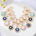 Gold Tone Crystal Heart and Sun Evil Eye Clip Keychains view 1