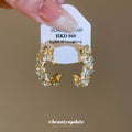 White Flower And Green Leaf Hoop Clip On Earrings With Polished Metal Details view 2