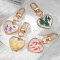 Gold Tone Heart Pressed Botanical Resin Clip Keychains view 1