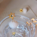 Gold Snowflake Stud Earrings With White Fur Pom Drop view 1